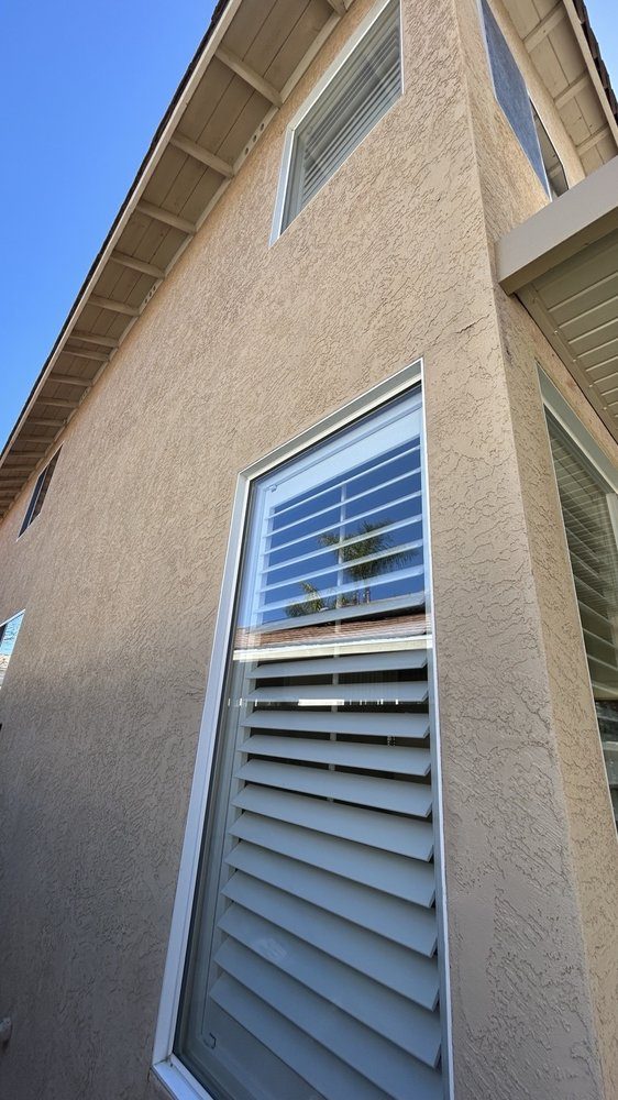 Second-story window on a stucco home
